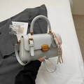 Light gray square handbag with gold metal clasp and tennis racket charm accessory - Gray