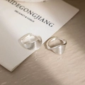 Detail of twisted silver earrings with fine textured ridges and glossy metallic finish - Silver Shell Texture Wave Huggie (EH791YS)