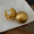 Close-up of golden brushed metal hoop earrings with a matte vintage texture and hinge - Brushed Matte Gold (DD-TE123-gold)