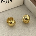 Close-up of gold semi-sphere stud earrings with star-set zircon on cream tray - Starburst Zirconia Gold (DDTE429JS)