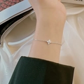 Close-up of silver clover bracelet with sparkling zircon stones worn on the wrist - Silver Micro-Pave Zirconia Clover Bracelet (S-B800-Silver)