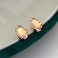 Vintage rose gold opal earrings set on a dark green velvet jewelry box with retro texture - Opal Stud Earrings