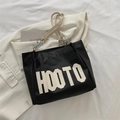 Black leather tote bag with bold HOOTO lettering and cream chain shoulder straps - Black
