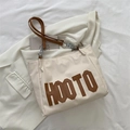 Off-white canvas tote bag featuring brown HOOTO applique and metal chain handles - Khaki