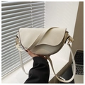 Detail showing white lychee grain leather saddle bag with Made in China embossing and gold hook - White