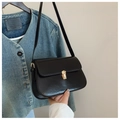 Detailed close-up of glossy black leather shoulder bag with elegant gold metal lock buckle - Black