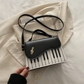 Fashionable piano key handbag with gold treble clef accent and cross-body strap - Black