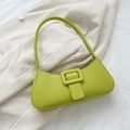 Chic lime green baguette bag with decorative square buckle on a beige blazer - Green
