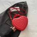 Red heart-shaped handbag with embossed concentric pattern and pleated handle strap - Red
