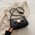 Minimalist black faux leather underarm bag with gold metal buckle on white blazer - Black