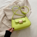 Neon green baguette shoulder bag with gold square buckle on a beige blazer - Green