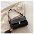 Detail of elegant gold rotary lock on black leather shoulder bag with flap design - Black