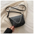 Close-up of black crescent bucket bag with silver chain and subtle cartoon print detail - Black