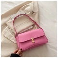 Detail of rose pink leather handbag with gold bar metal clasp and adjustable shoulder strap - Pink
