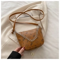 Detail of brown litchi pattern bucket bag with cartoon bear print and silver chain strap - Brown