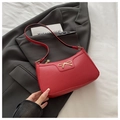 Detail showing red litchi grain leather texture and golden bow ornament on the handbag - Red Lychee Pattern Bow Style / Red