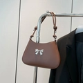 Dark brown matte leather underarm bag with silver bow accent and knotted strap detail - Brown