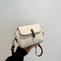 Cream vintage crossbody bag with dark brown contrast straps and lychee leather texture - White