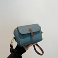Blue lychee pattern crossbody bag with brown leather strap and gold hardware detail - Blue