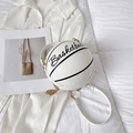 White basketball shaped crossbody bag with black stripes and golden chain strap - White
