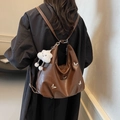 Vintage brown PU leather hobo backpack featuring silver butterfly charms and plush pendant - Coffee