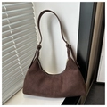 Detail of a dark brown suede hobo bag with knotted straps and natural light shadows - Coffee Suede
