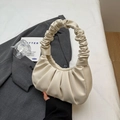 Chic pleated off-white handbag with ruched handle on grey blazer background - White
