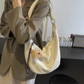 White crescent crossbody bag with lychee pattern leather and plush toast charm - Off White