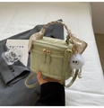 Light green textured box bag with scarf-wrapped handle and plush charm detail - Green
