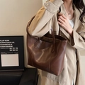 Deep brown matte leather tote bag for women showing spacious interior and sleek shoulder design - Brown