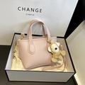 Pink lychee grain leather bucket bag with monkey charm in a white premium gift box - Pink