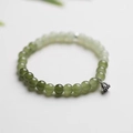 Detail of gradient green jade beads with a silver lotus seed pod charm pendant - Gradient Nephrite Jade Bracelet with Lotus Pod
