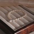 Elegant S925 silver freshwater pearl bracelet with delicate lotus pendants in warm lighting - Pearl Lotus Pod Pendant Style