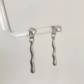 Macro detail of irregular geometric wavy drop earrings in silver liquid metal finish - Silver Irregular Geometric Wave Style