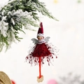 Christmas angel doll ornament with red tassel dress and wings on snowy pine branch - Red