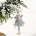 Christmas angel doll ornament with gray faux fur skirt and silver wings hanging on pine - Gray
