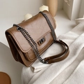 Deep brown quilted crossbody bag with vintage chain strap on soft white background - Brown