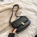 Minimalist black leather crossbody bag featuring a vintage rectangular metal twist lock - Black