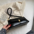 Chic black baguette bag with gold twist lock and slim shoulder strap for women - Black