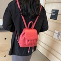 Minimalist red leather backpack for women with drawstring and textured lychee pattern finish - Burgundy