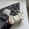 Chic beige ruched cloud bag with silver chain strap on modern minimalist background - Off White
