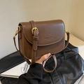 Elegant vintage brown leather saddle bag with gold buckle and adjustable shoulder strap - Brown