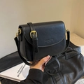 Classic black leather saddle cross-body bag with embossed fashion logo and adjustable strap - Black