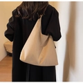 Detail of a beige faux suede tote bag showing its soft structure and large capacity on shoulder - Shoulder Bag Set / Off White