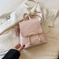 Chic pink glossy mini backpack with flap closure and adjustable straps on white blazer - No Pendant / Pink