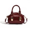Glossy burgundy bowling bag with gold hardware and detachable shoulder strap - Red