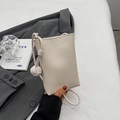 Minimalist beige mini crossbody bag with knotted rope strap and pebbled leather texture - Off White