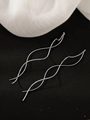 Detail of silver wavy long line earrings on black fabric with elegant white tulle - Wave Ear Thread / White Gold