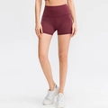 High-waisted burgundy yoga shorts for women featuring elastic bodycon fit and squat proof fabric - 8/L / Bottoms / Red Brown