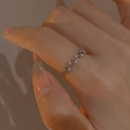 Macro shot of S925 silver intertwined vine ring with zircons on a finger - Adjustable Open / Silver